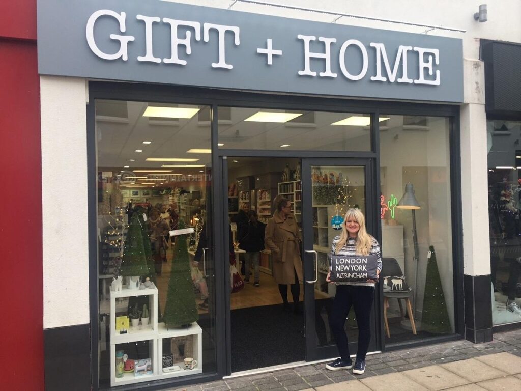 The Gift + Home shop in Altrincham town centre with a grey sign and white lettering